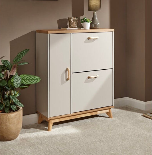 Modern grey and wooden shoe rack placed in an entryway with decorative plants and wall art.