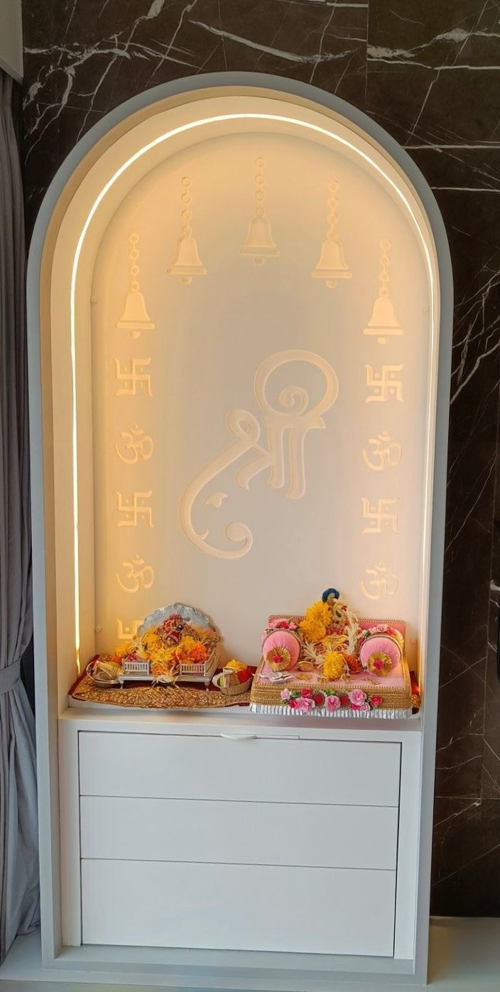 Elegant white Corian home temple with illuminated Shree symbol and sacred motifs, designed for compact and luxurious prayer spaces.