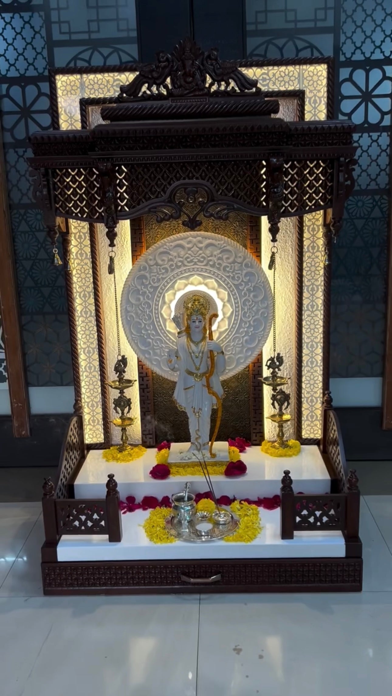Elegant dark walnut finish pooja mandir with marble base and floral back design for spiritual interiors.