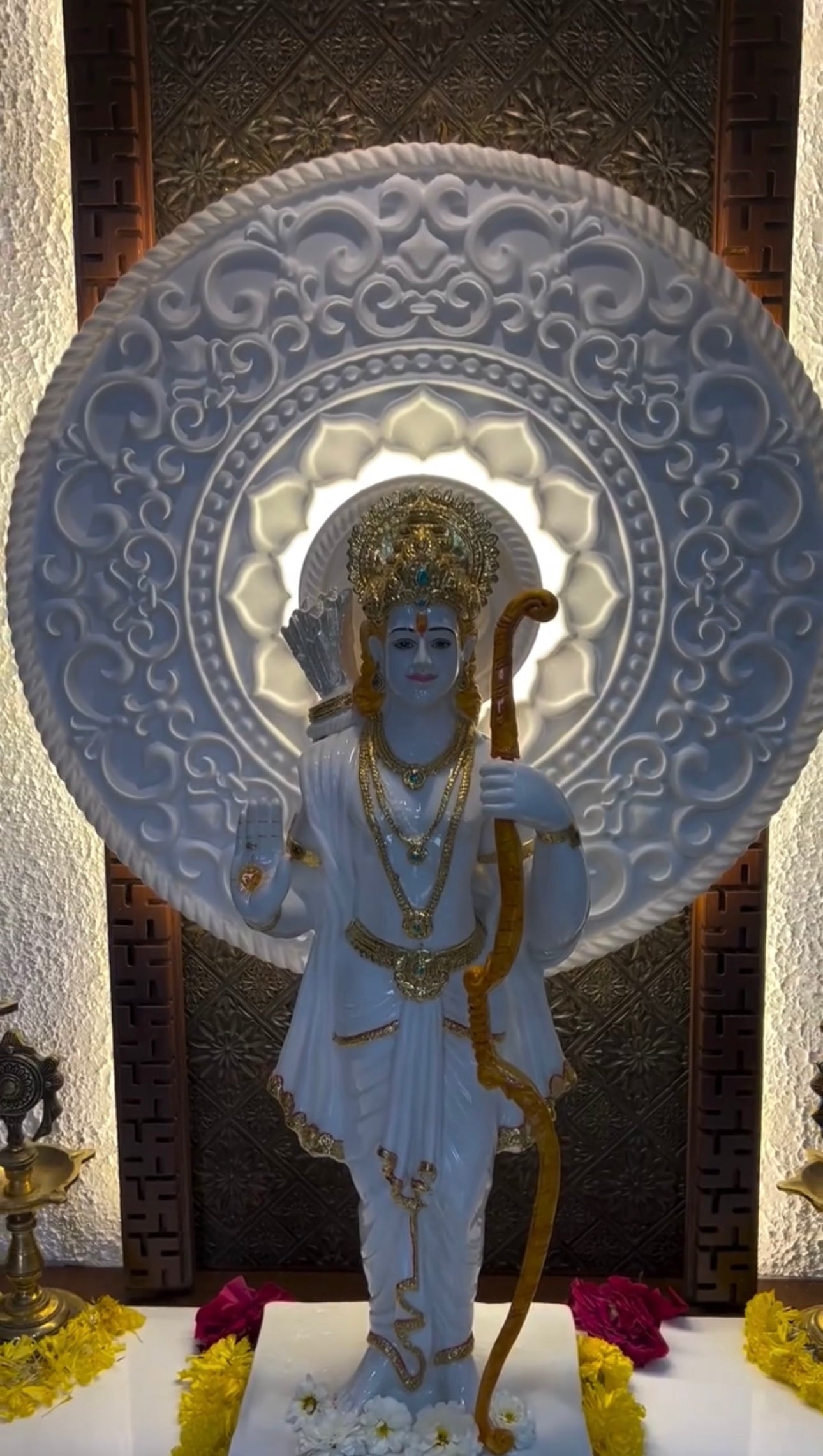 Luxurious wooden pooja mandir with designer paneling and idol space, ideal for living room decor.