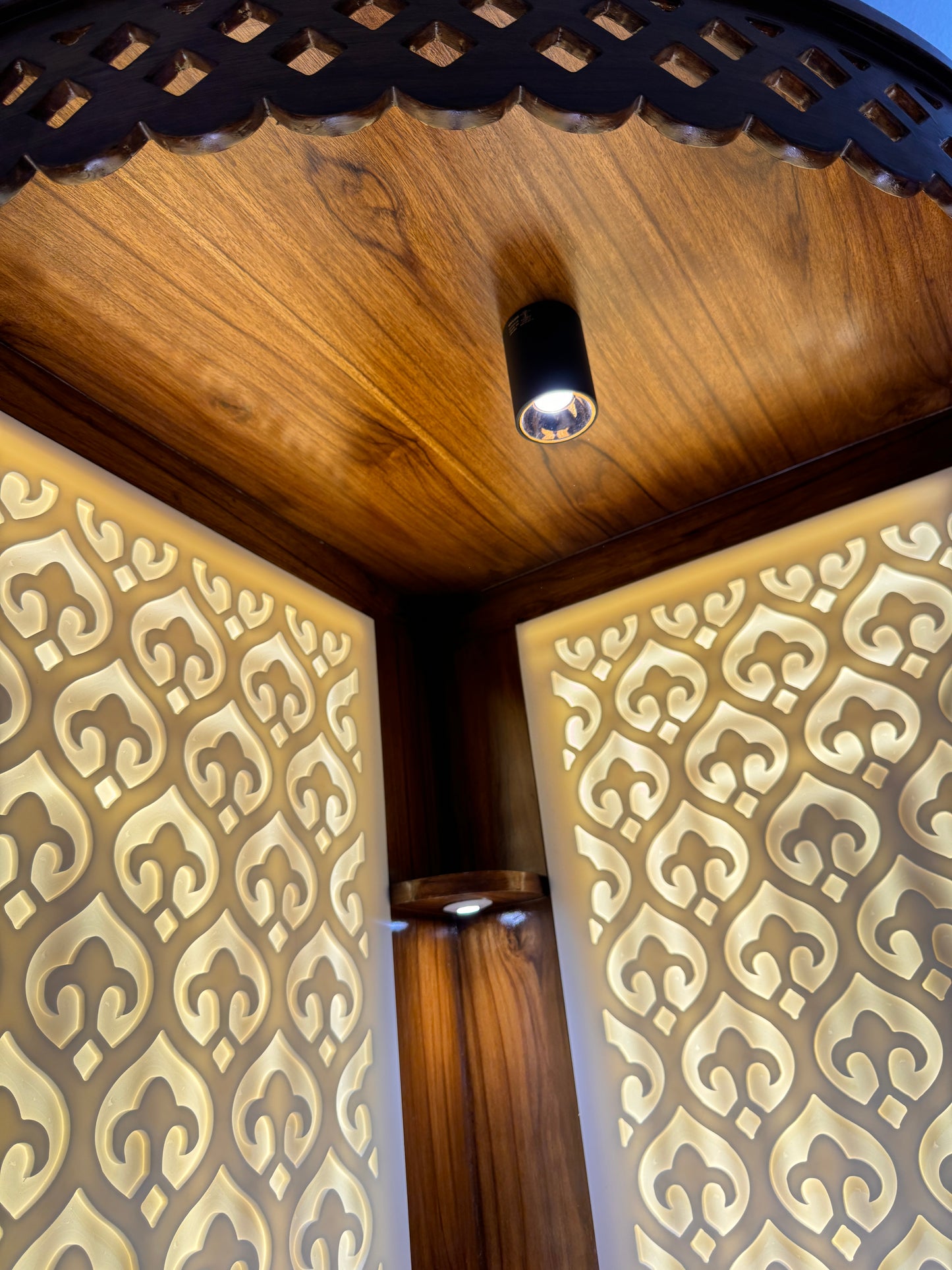 Custom-designed Corian mandir for modern interiors with soft LED backlight