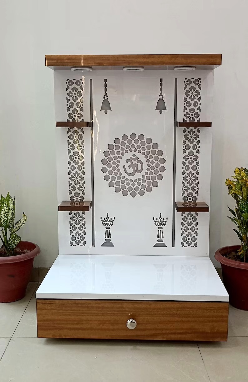 Modern wooden mandir with OM laser cut, drawer storage, hanging bells, and side panels for home prayer room setup