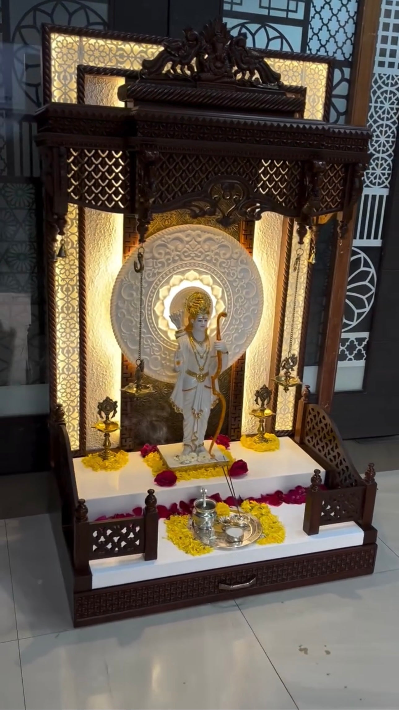 Handcrafted wooden pooja mandir with ornate carvings and warm LED lighting for modern Indian homes.