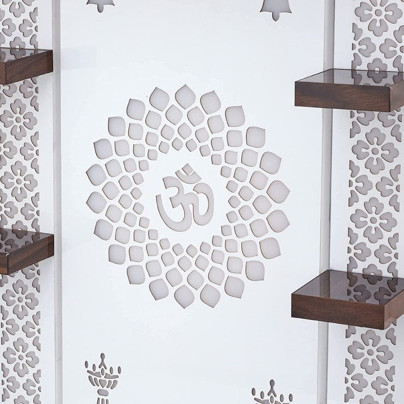 Contemporary mandir design with Om centerpiece and bell motifs for living room decor