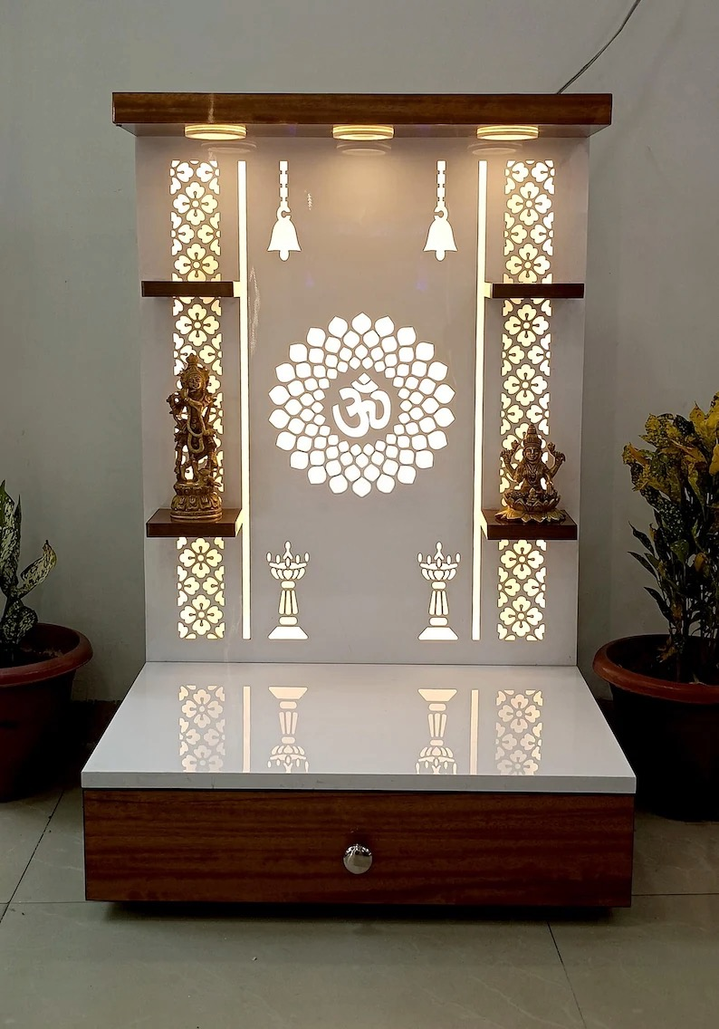 LED spotlights mounted on wooden panel of modern Pooja mandir, enhancing the spiritual ambiance with focused illumination on idols.