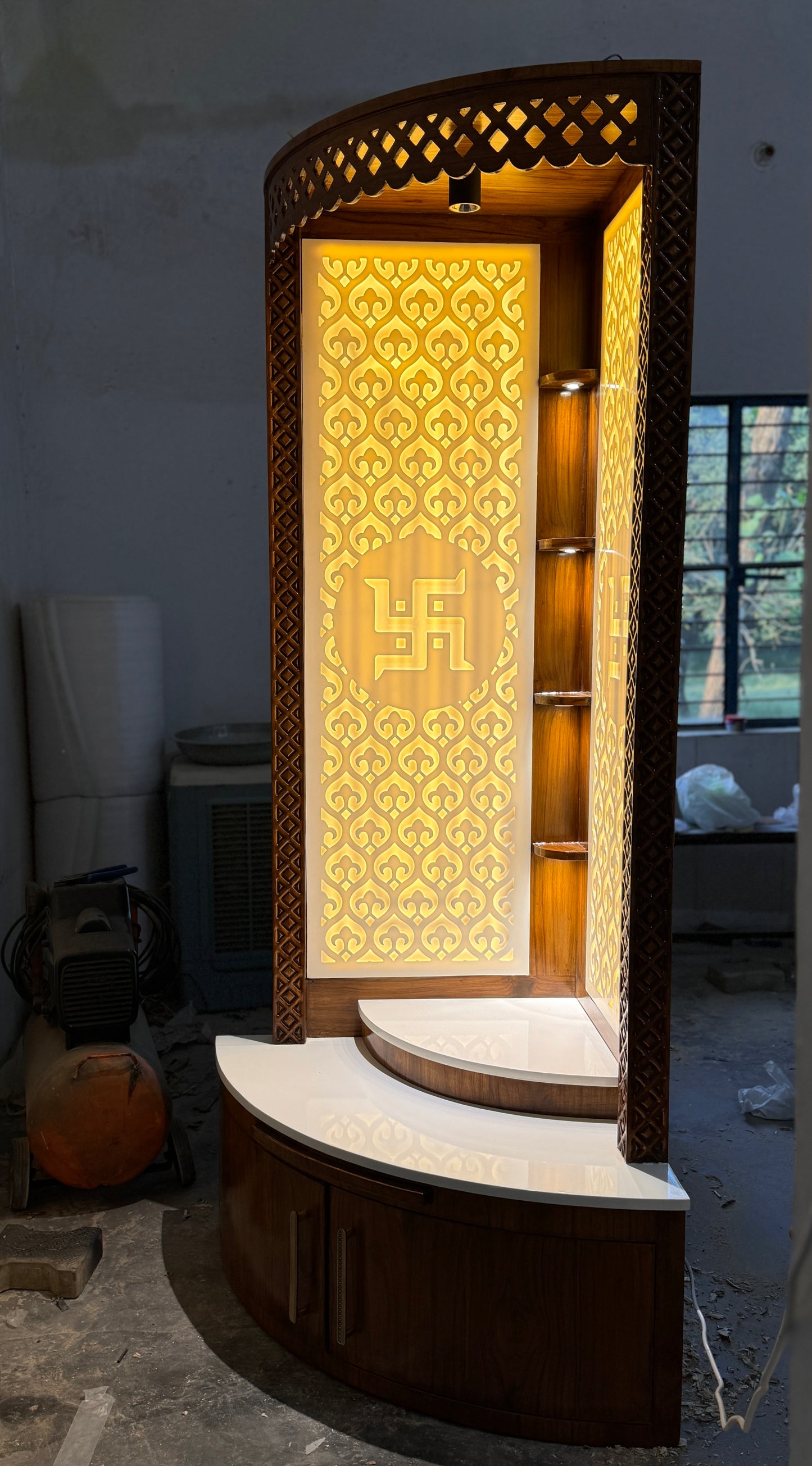 Handcrafted teakwood and Corian pooja mandir with corner-fit design and LED Swastik panel
