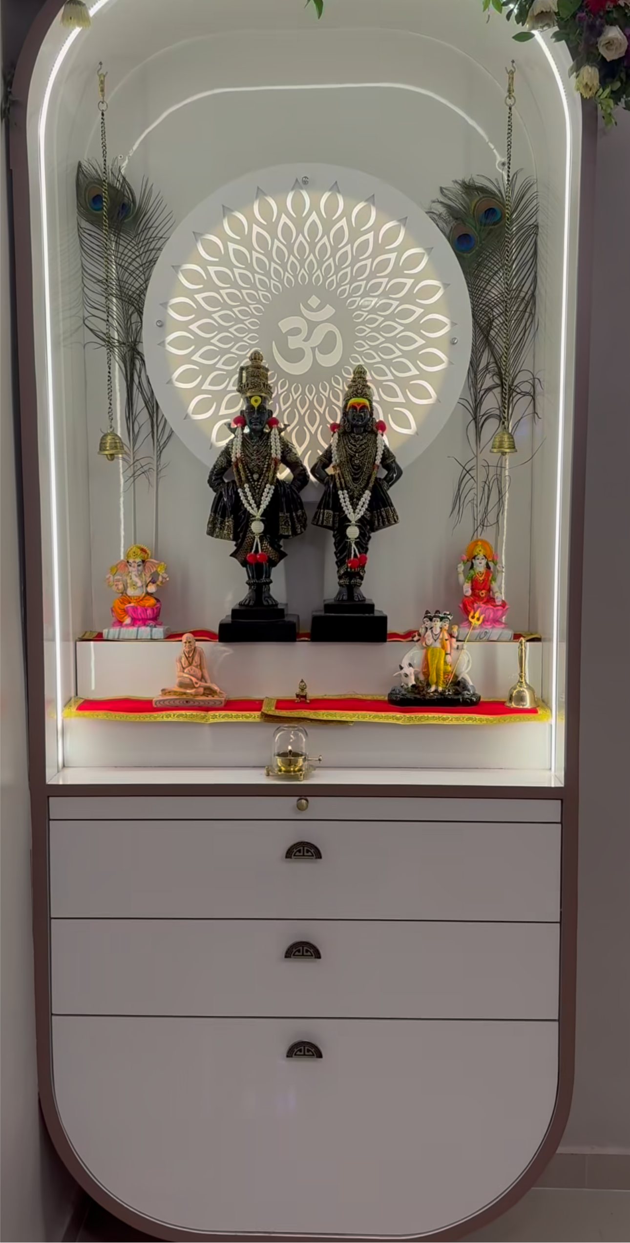 Stylish Pooja Mandir with drawer storage, floral arch, LED backlight, and spiritual idols including Ganesh, Lakshmi, and Krishna.