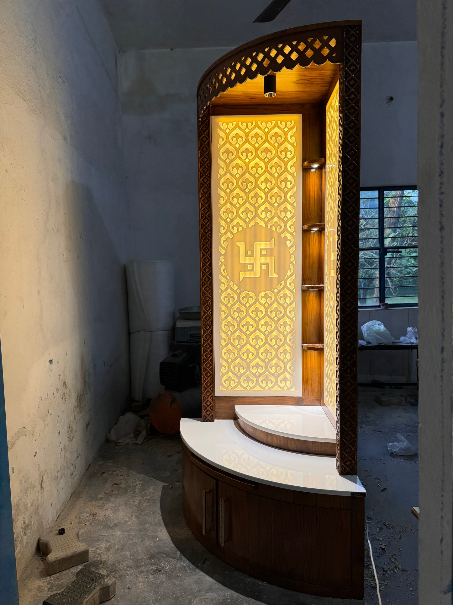 Space-saving modern pooja unit made from teakwood and Corian for contemporary homes