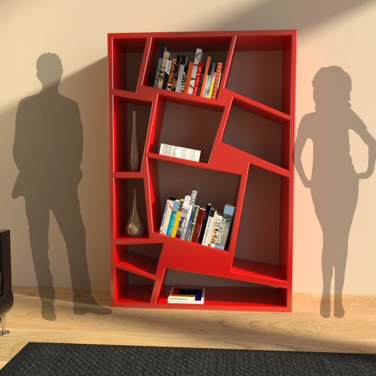 Front view of a modern red asymmetrical bookshelf with decorative compartments, flanked by silhouettes of a man and woman for scale, against a beige wall and wooden floor.