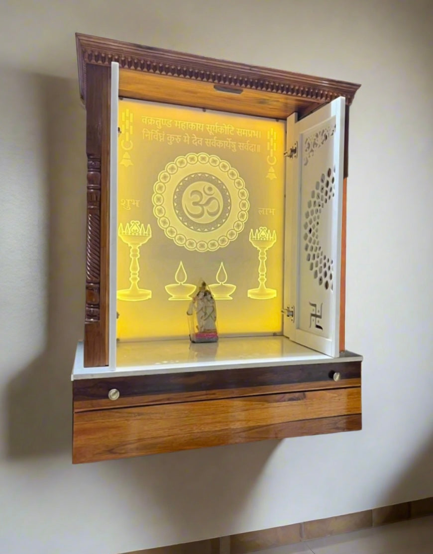 Elegant wall-mounted mandir made from high-quality teakwood and Corian, featuring a glowing Om backdrop and spacious deity platform.