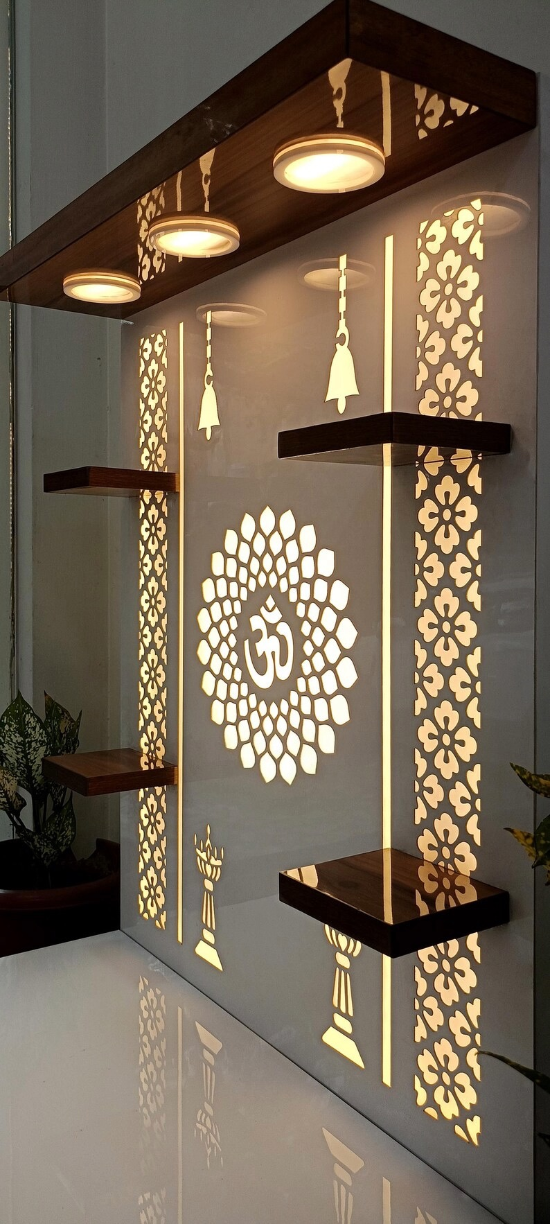 Minimalist wooden and white laminated Pooja mandir with Om laser cut design and LED backlight, ideal for compact spiritual spaces.