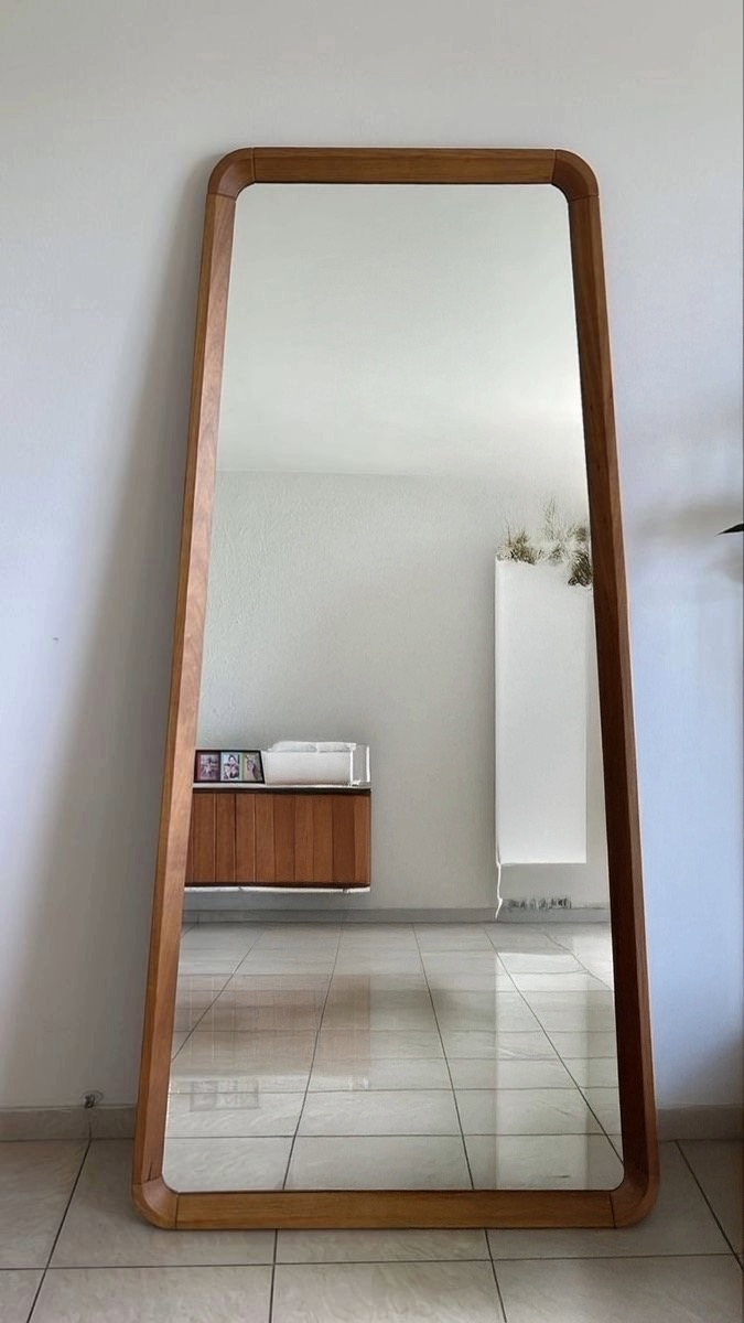 Tall wooden frame mirror with sleek minimalist design, perfect for bedrooms or entryways