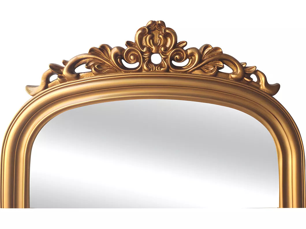 Close-up of intricate gold floral carving on the top of an arched full-length mirror frame.