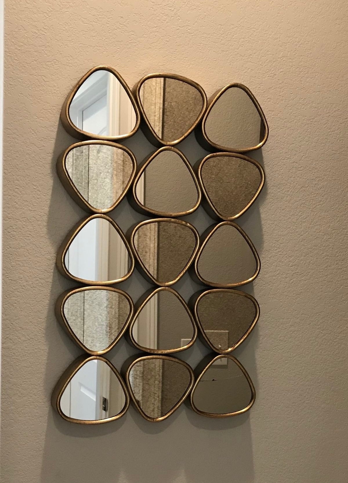 Decorative accent mirror with 15 gold-framed geometric mirrors, ideal for living room or hallway