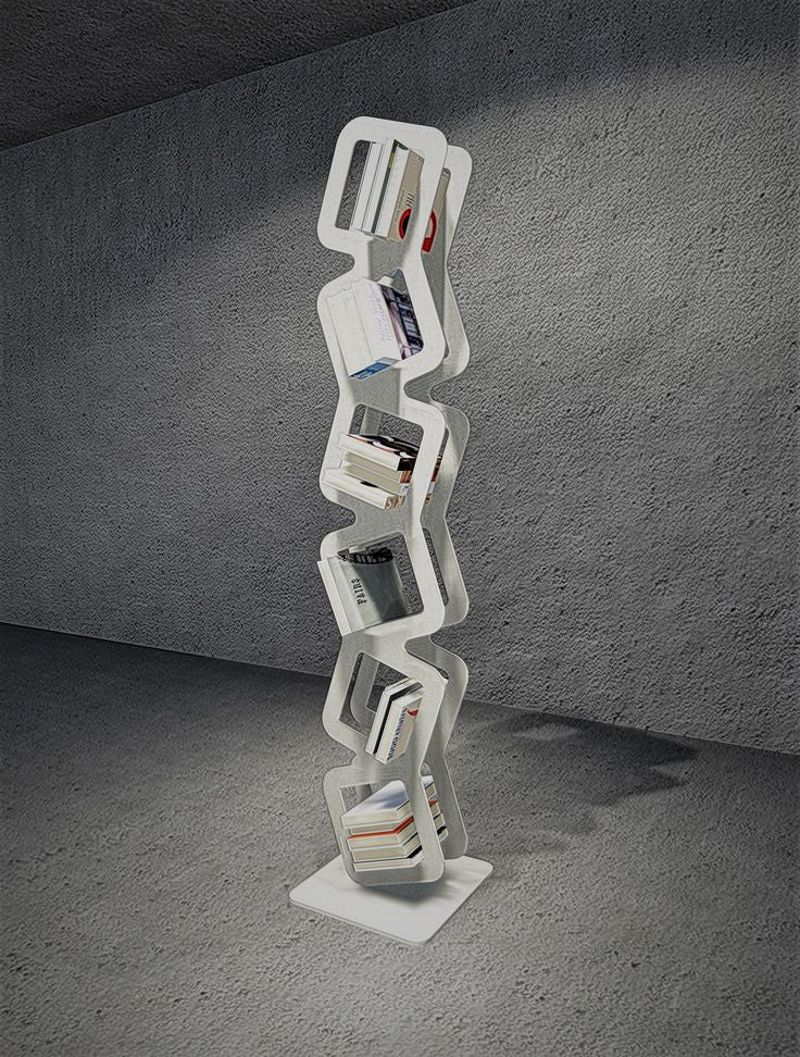 Sleek gray modern bookshelf with zigzag design and geometric compartments, showcasing books in a minimalist interior setting.