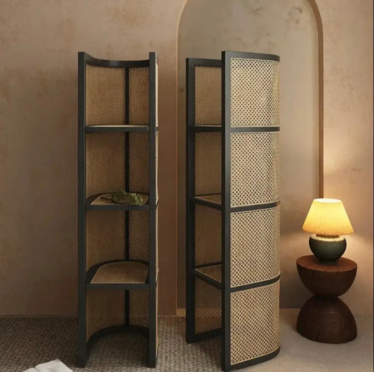 Elegant cane and wood shelf used for storage and display, holding everyday items like books, candles, and storage boxes, demonstrating both function and form.
