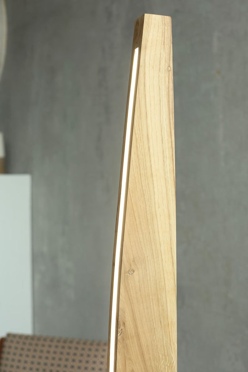Close-up of curved wooden floor lamp showcasing natural wood grain and built-in LED strip, perfect for ambient lighting.