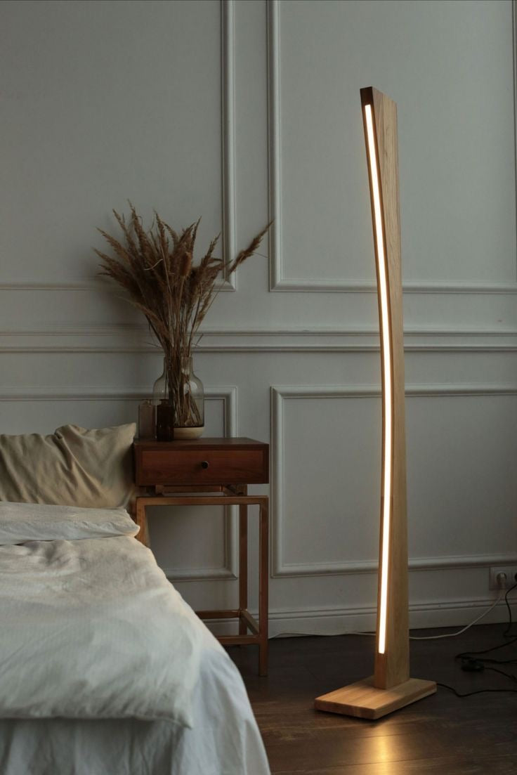 Soft ambient lighting from minimalist curved wooden LED floor lamp for mood lighting in modern interiors.