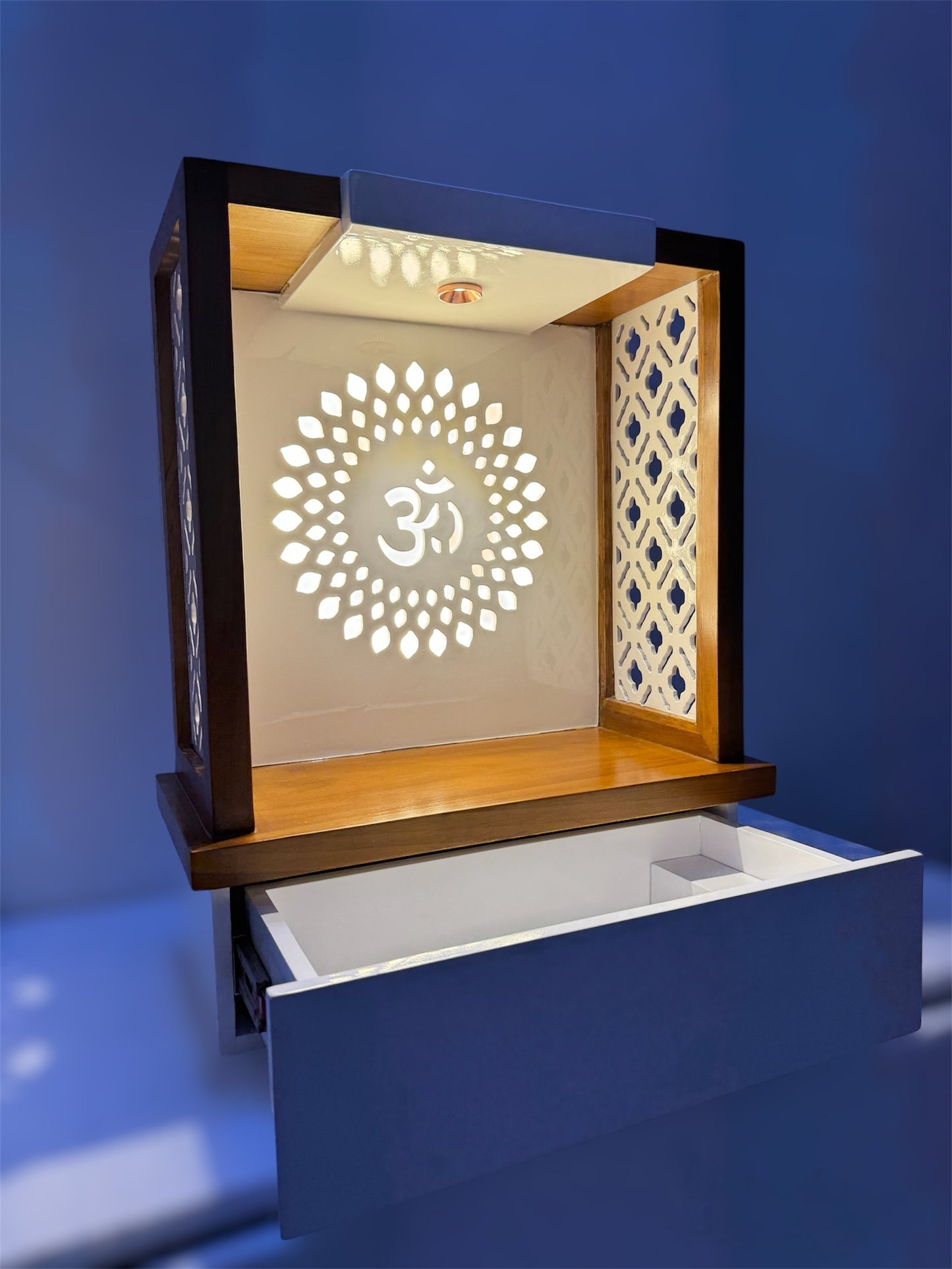 A fusion of traditional and modern design, this elegant wooden pooja mandir features laser-cut side panels, a pull-out drawer, and LED illumination for a serene ambiance.