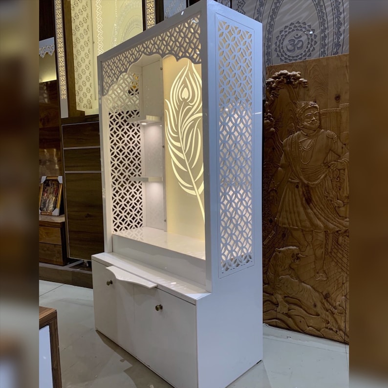 A stylish home temple with a glowing Krishna feathers symbol, intricate laser-cut patterns, and warm LED lighting, adding serenity to your space.