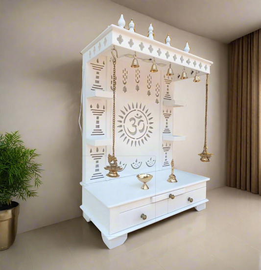 White wooden pooja mandir with Om design, brass bells, and hanging diyas
