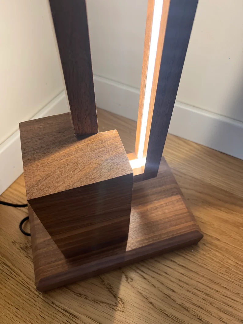 Wooden lamp with a light on a wooden surface