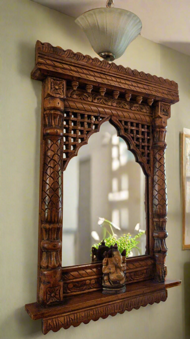 Vintage wooden Jharokha wall mirror with hand-carved arch design and Ganesh idol – traditional Indian decor piece.
