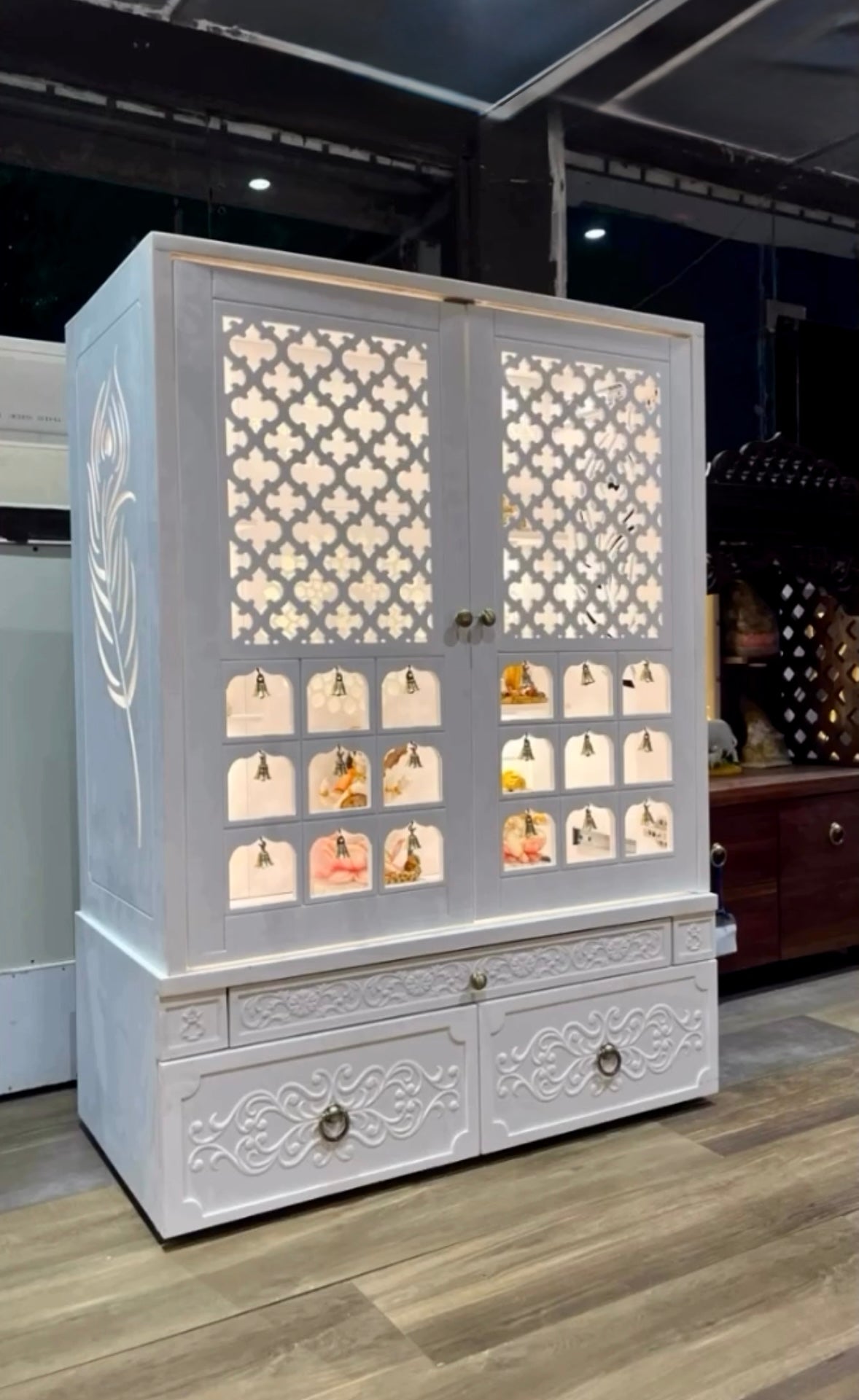 Compact wooden puja mandir in matte white finish with traditional decor