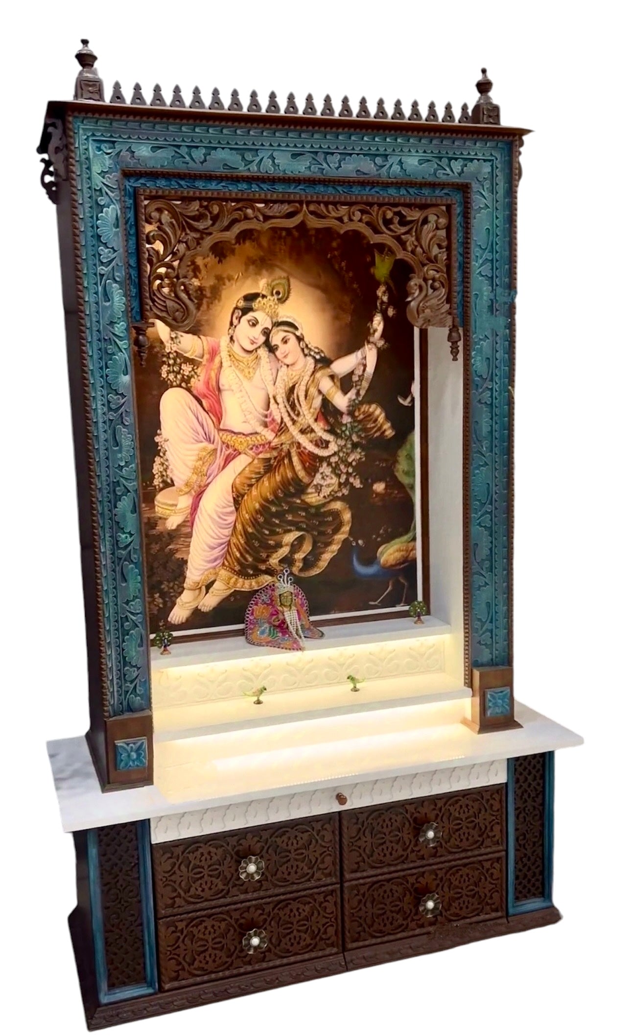 Exquisite large wooden pooja mandir with a dark brown and peacock color finish, featuring a divine Corian Radhe Krishna image and intricately carved drawers.