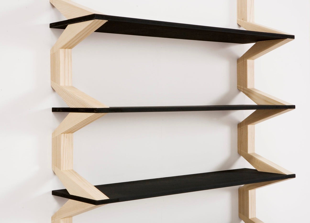 Detailed view of the precision-cut wooden supports and black shelves, showcasing craftsmanship and design.