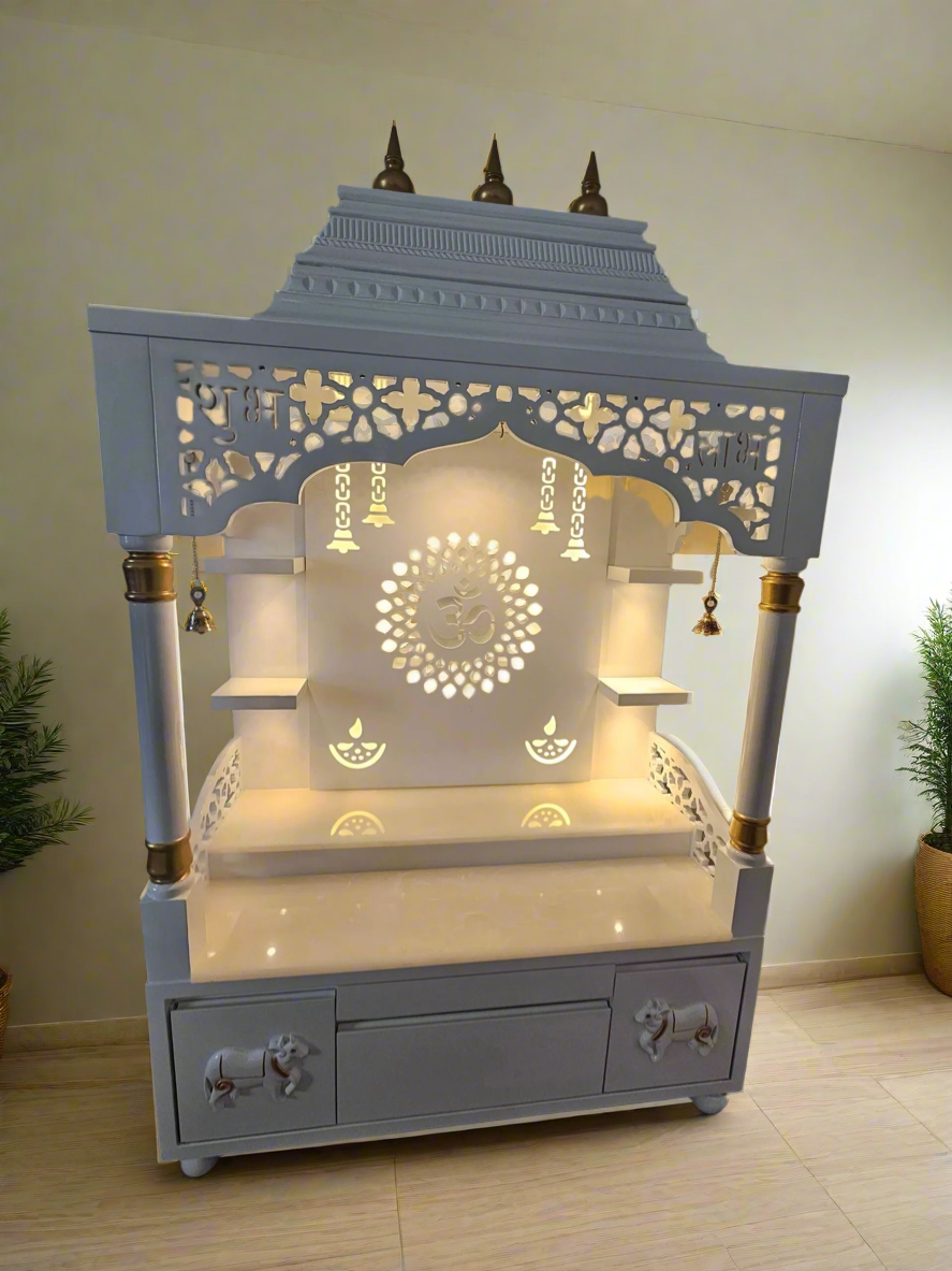 Decorated white home temple with idols, LED lights, and traditional Hindu pooja setup