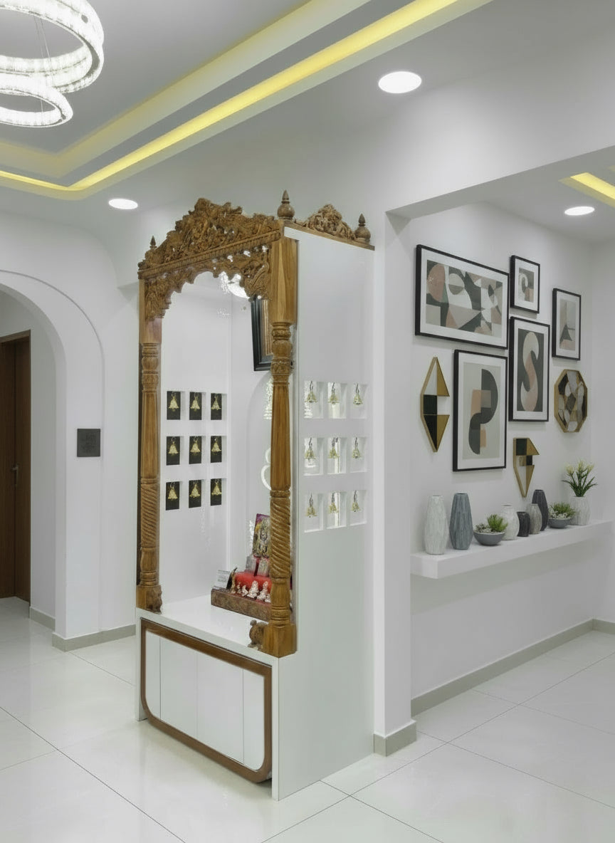 Handcrafted teakwood home temple featuring carved pillars, white acrylic backdrop, and elegant lighting