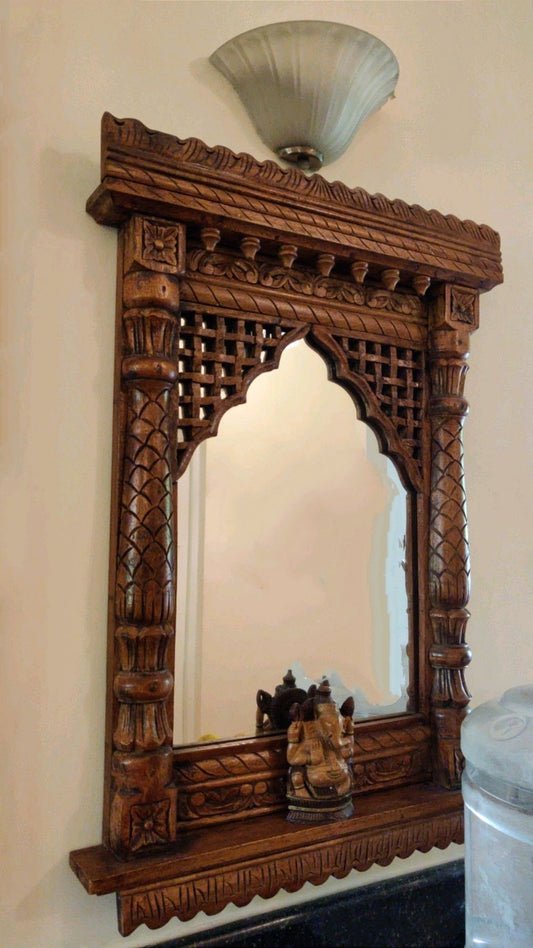 Handcrafted wooden Jharokha wall mirror with Ganesh idol and intricate lattice carving – traditional Indian wall decor.