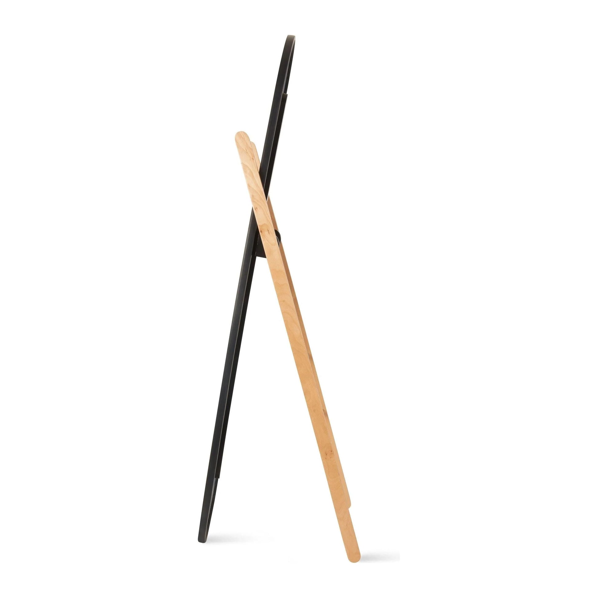 Side profile of sleek black oval standing mirror with wooden support frame