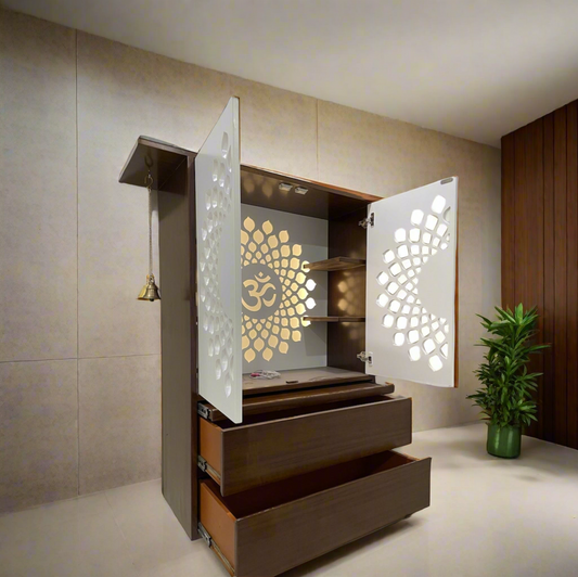 A beautifully crafted wall-mounted wooden pooja mandir featuring intricate white doors with laser-cut floral patterns, LED backlighting, and an "Om" symbol at the center. Designed for compact spaces with pull-out drawers for storage.