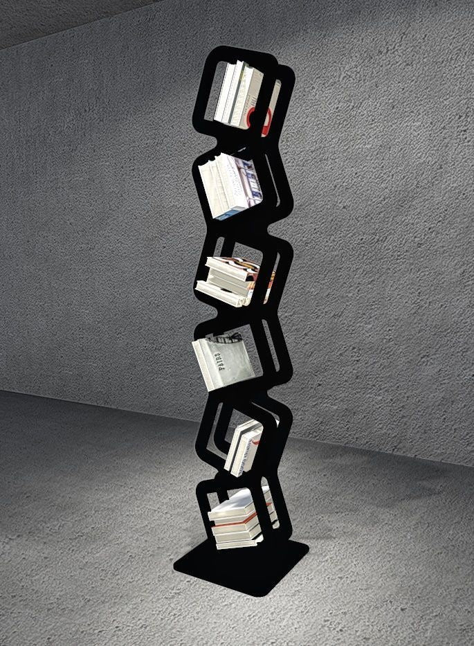 Contemporary black zigzag tower bookshelf with angled shelves, stylishly holding books in a minimalist room.