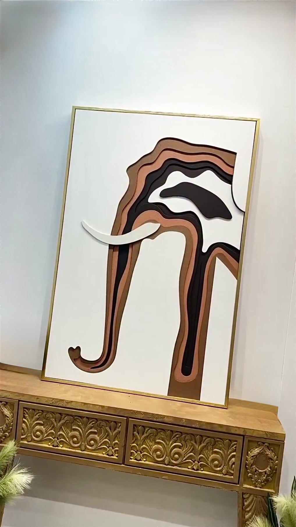 Modern 3D elephant wall art décor on carved console table with floral arrangement