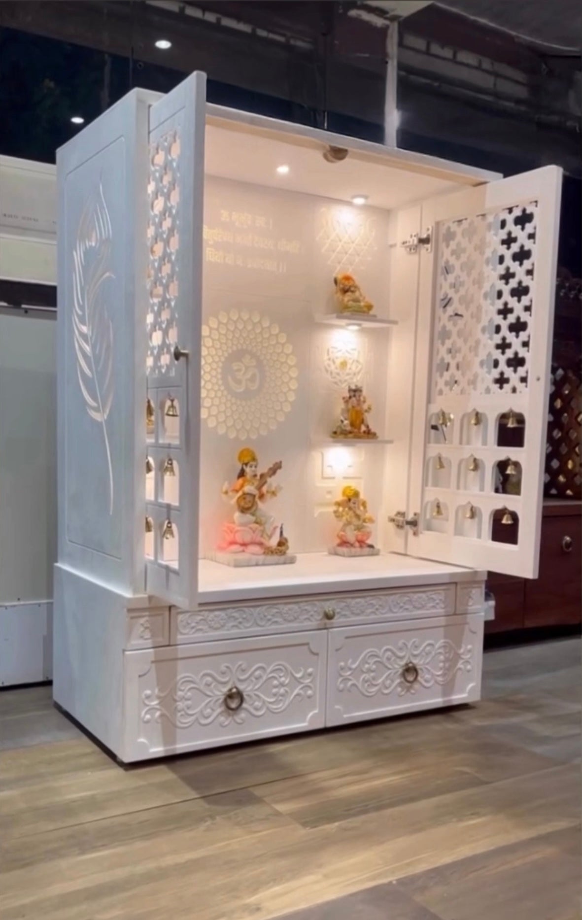 Modern wall-mounted home temple with bell and carved back panel design