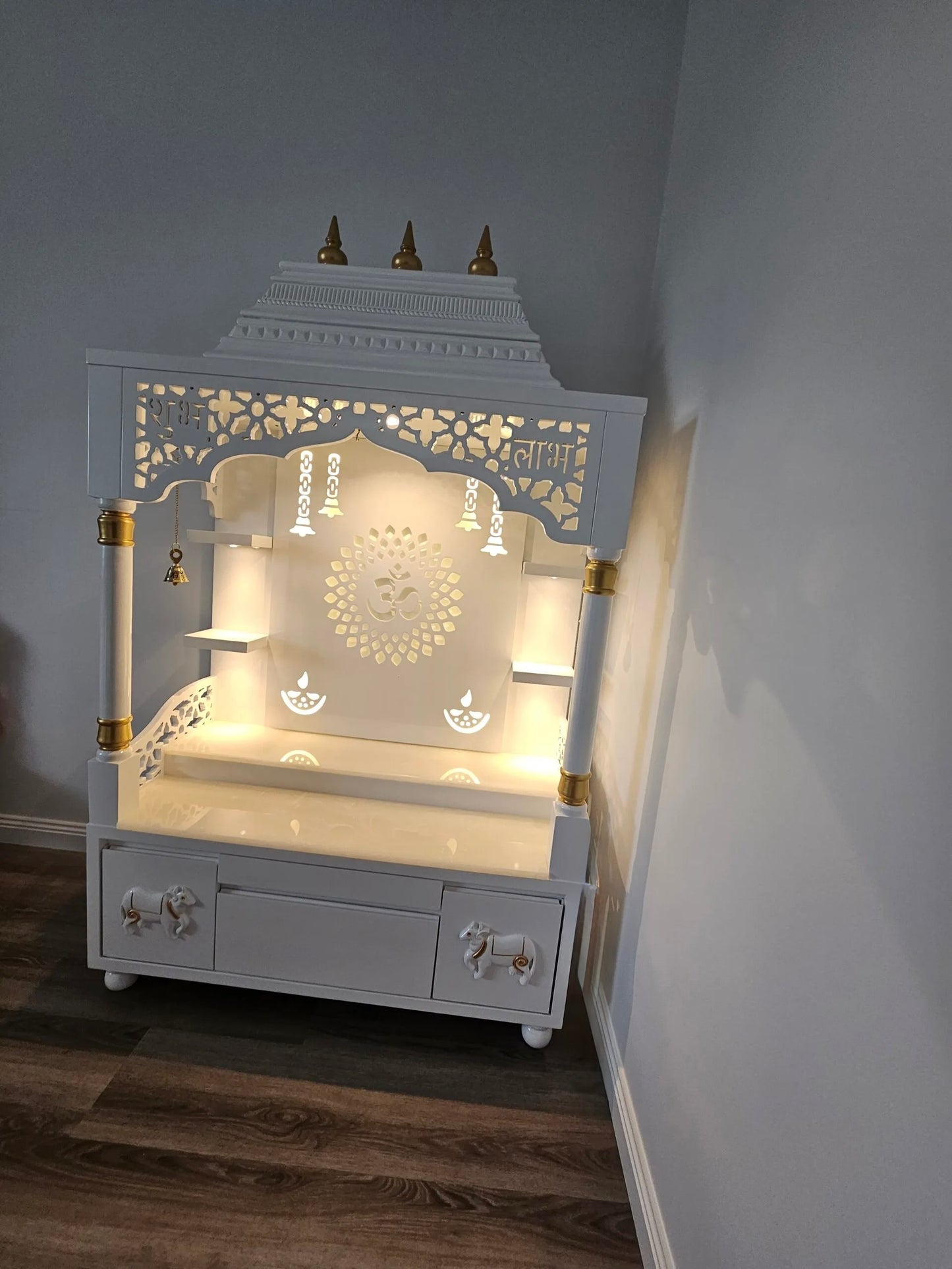 Elegant wooden home temple with LED backlight, traditional Indian pooja mandir with decorative pillars and storage cabinets