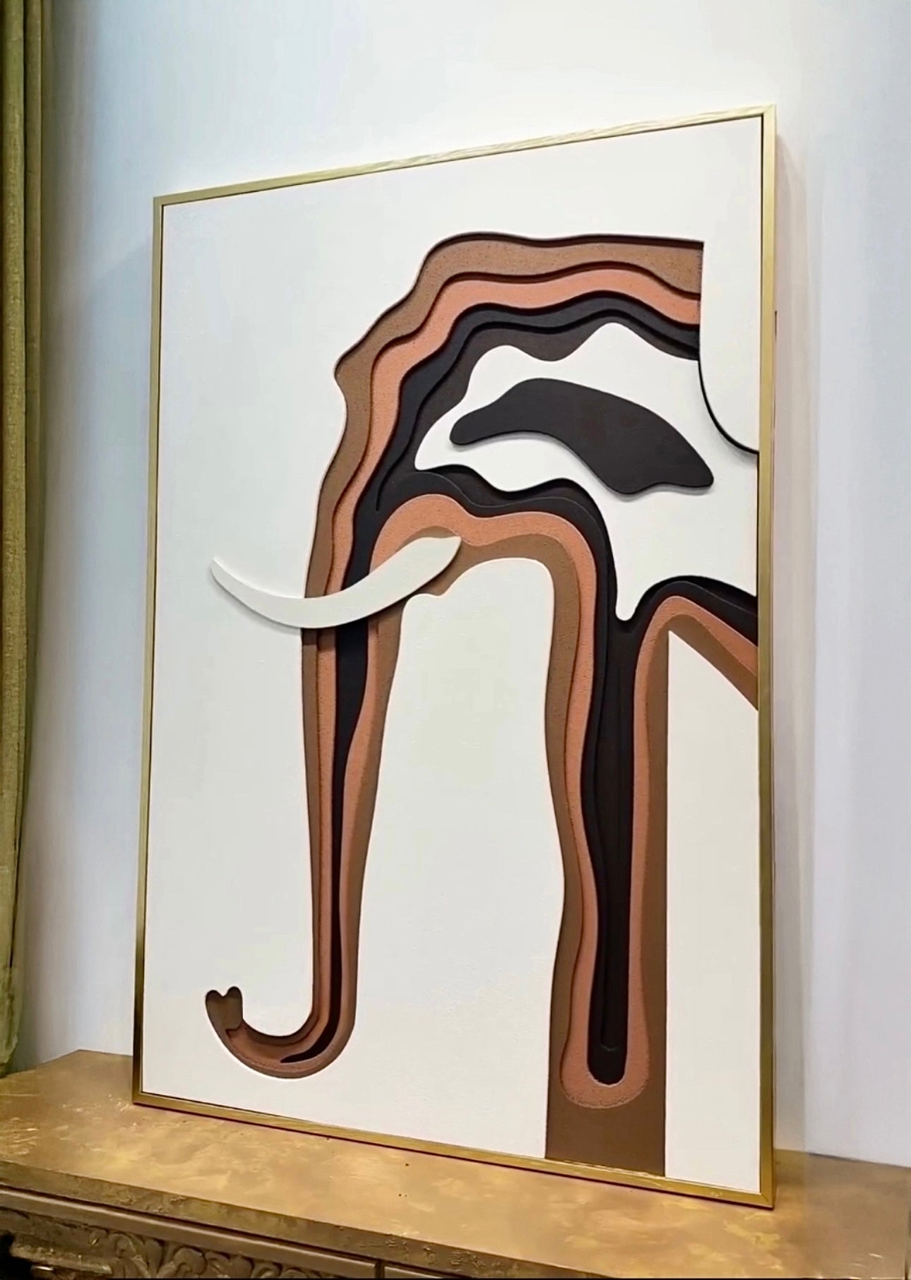 Close-up view of abstract layered elephant artwork with earthy brown and white tones