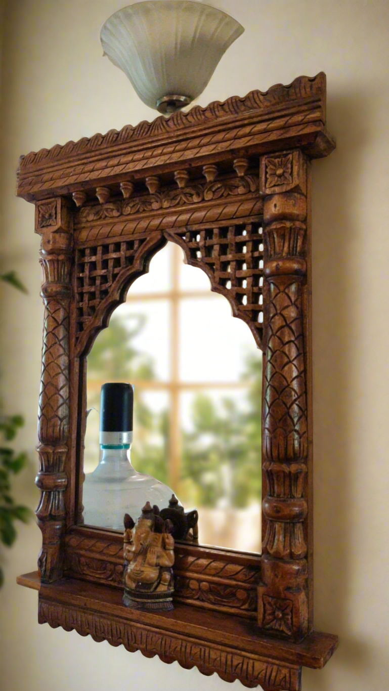 Rajasthani style carved wooden Jharokha mirror frame with detailed floral design and Ganesh statue for home decor.