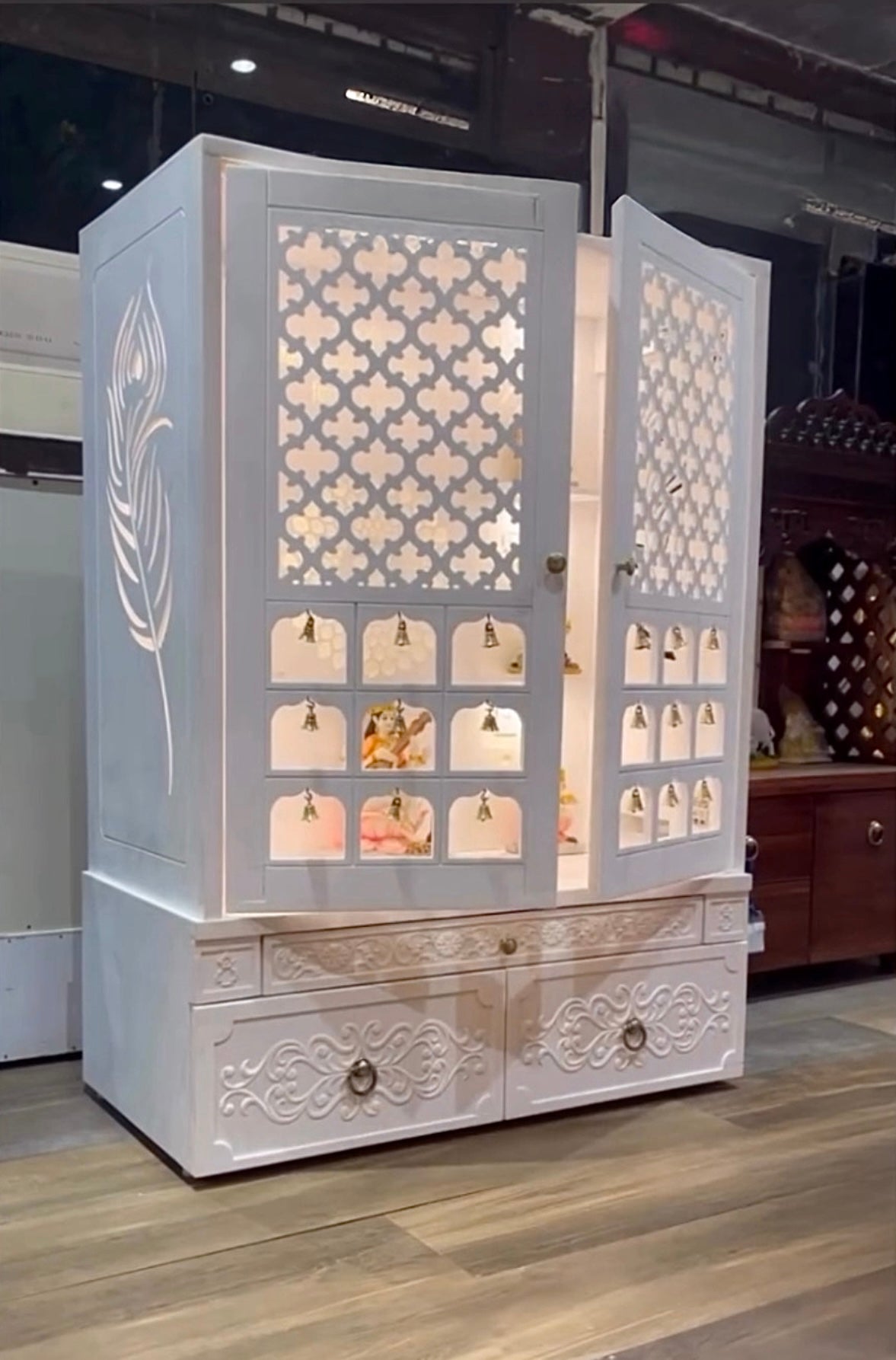 White wooden pooja mandir with LED light and drawer for Indian home interiors