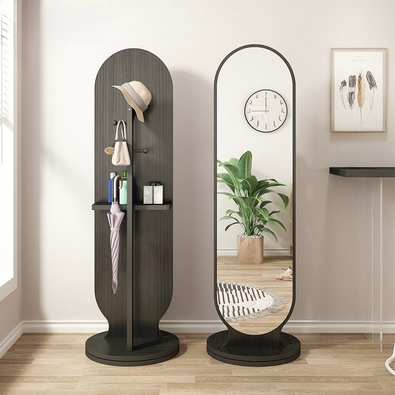 Modern black arched full-length standing mirror with 360-degree revolving mechanism and wooden storage rack for entryway and bedroom.