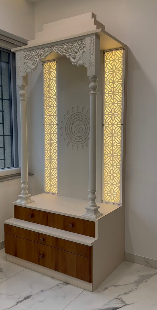 Handcrafted wooden Pooja Mandir with carved arch, glowing backlit jaali panels, and Om design in center