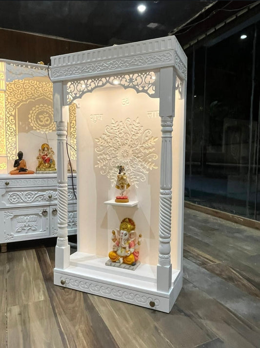 White wooden pooja mandir with LED Corian back panel and carved design for home temple.