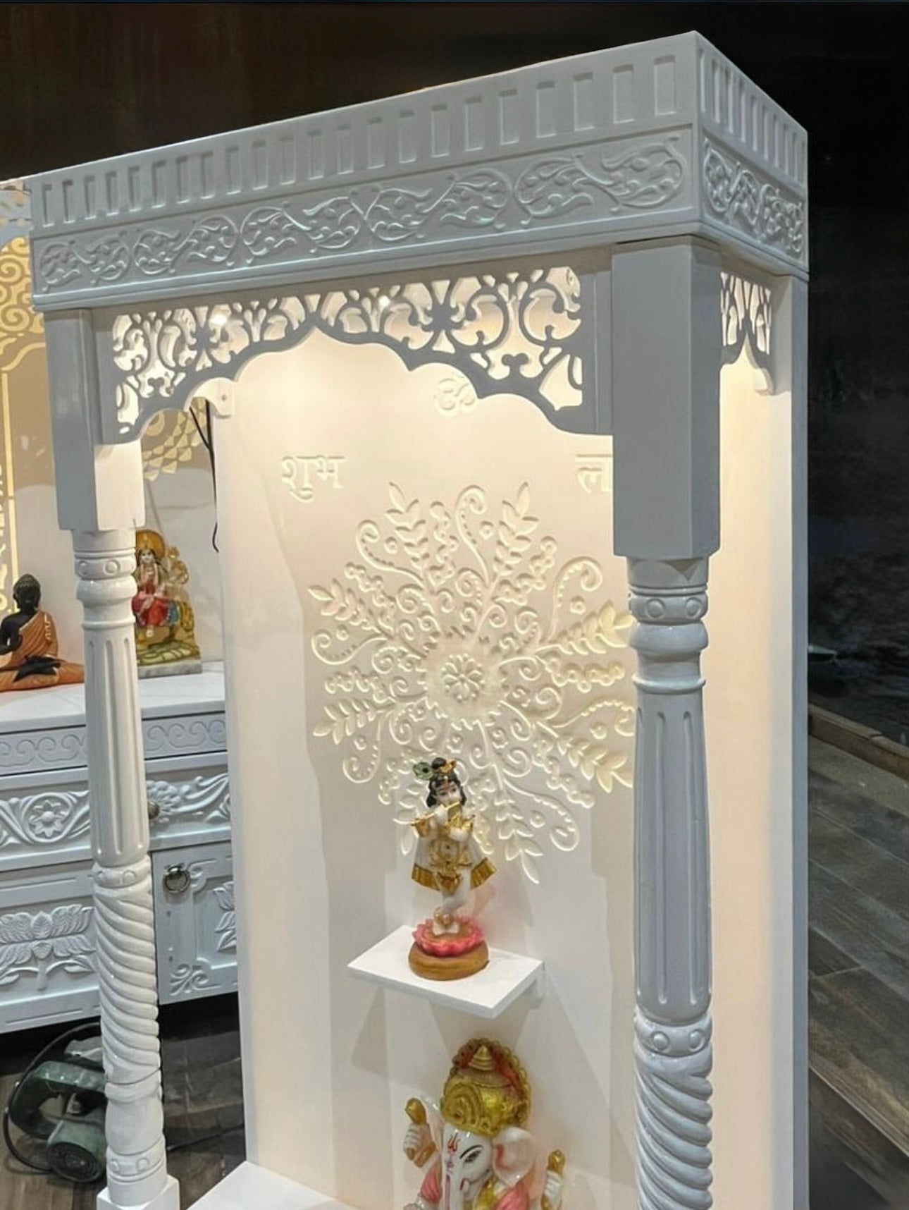 Elegant handcrafted wooden temple with drawer and Ganesha idol for home decor.