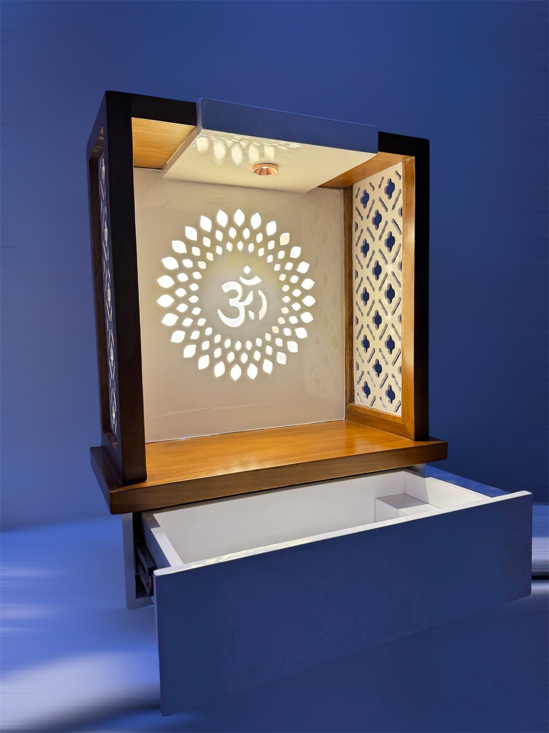 Space-saving wooden pooja unit featuring decorative side grills, pull-out drawer, and radiant backlit Om symbol to enhance your home’s spiritual aura.