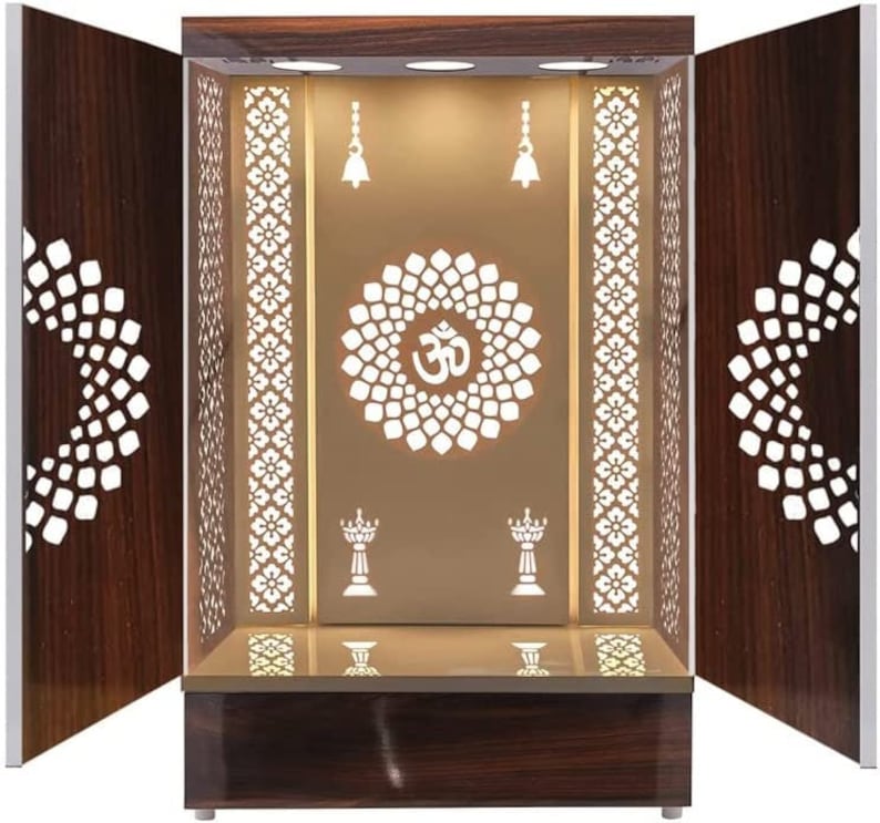 Wooden pooja mandir with intricate laser-cut floral design, white interior, and LED lighting, ideal for home temples.