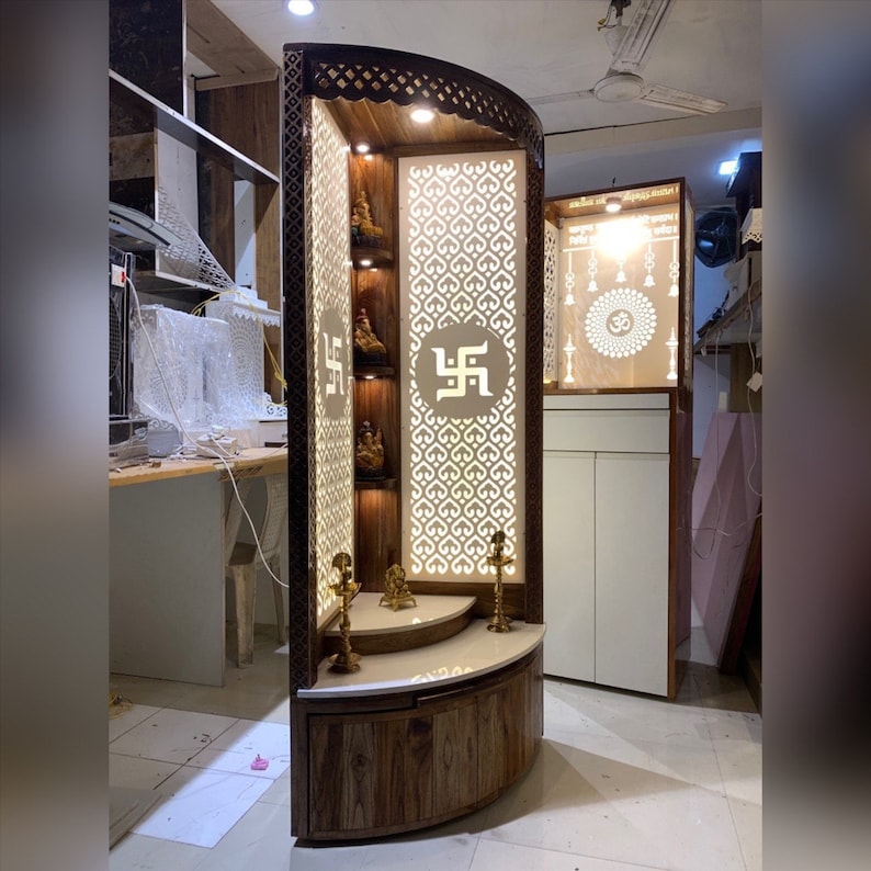 Modern home temple with a curved wooden storage cabinet, ideal for organizing religious books, incense, and Pooja essentials.