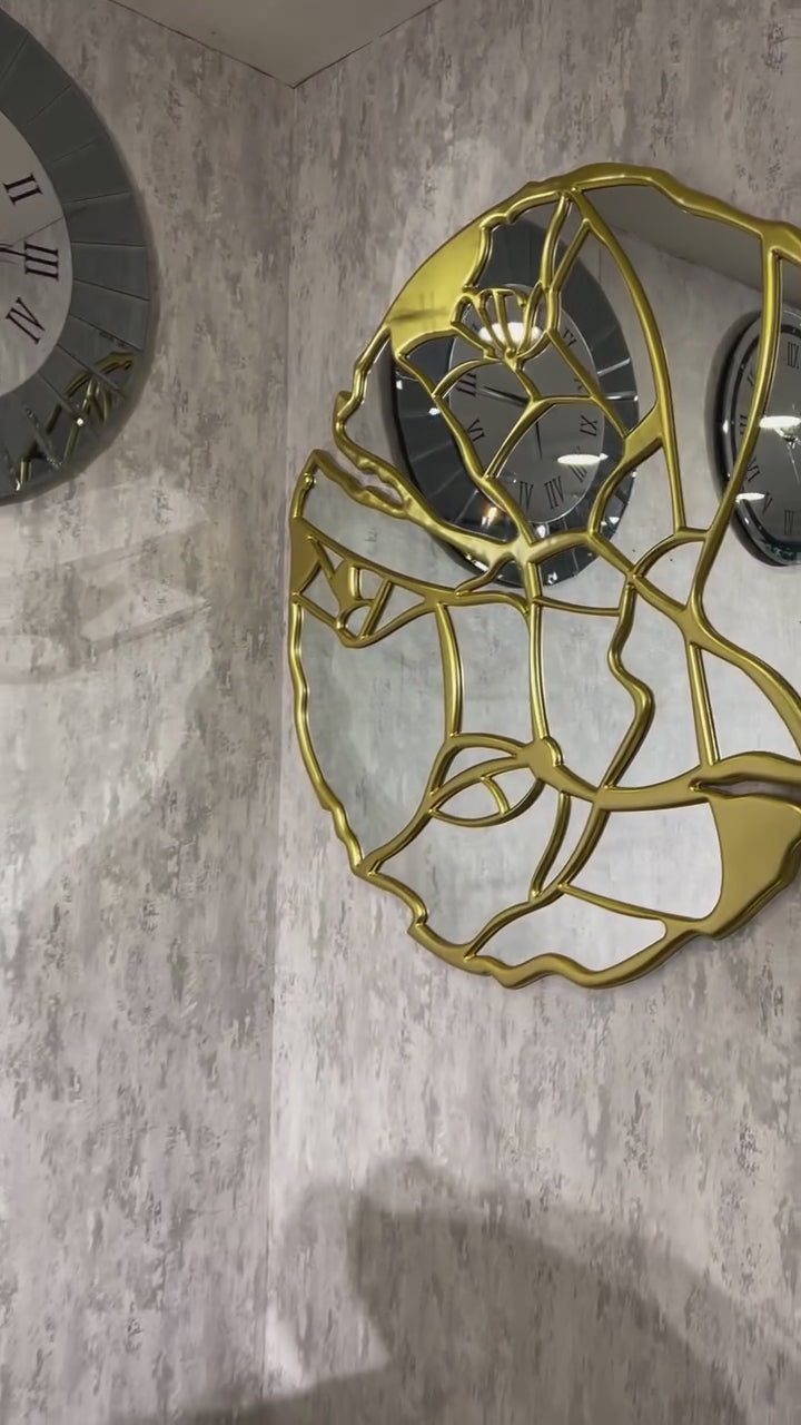Artistic gold-framed mirror with minimalist facial outline, ideal for glam or contemporary spaces
